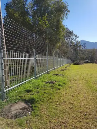 Clear View fence along a lawn with mountains in the distance