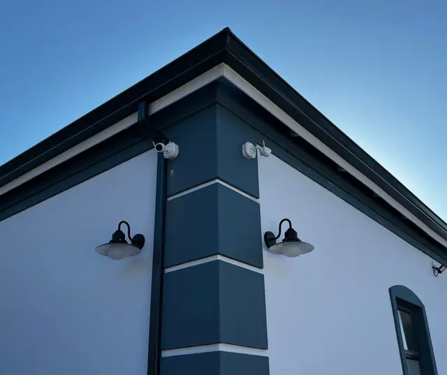 CCTV cameras mounted on the corner of a house