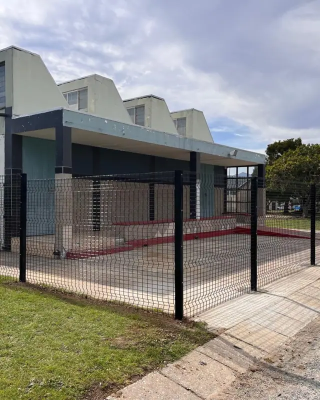 Clear View fence and gate beside a building